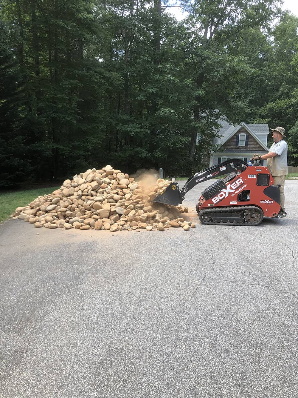 professional removing rocks in residential area