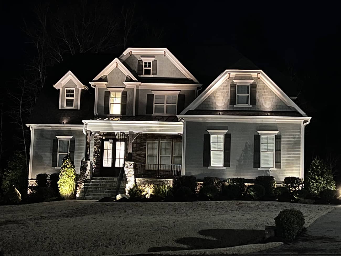 gray home with exterior lighting at night