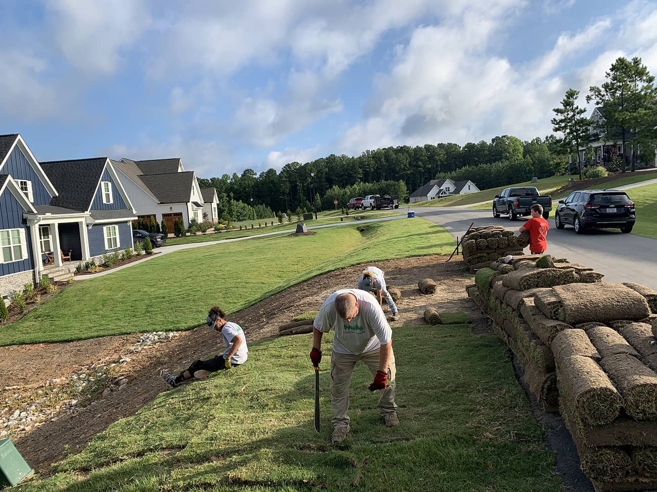 Distinct Lawns professionals laying sod in residential area