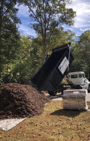 Distinct Lawns work truck dumping mulch